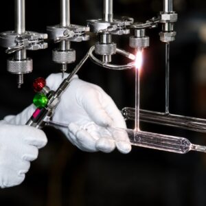 Technician using a precision vacuum manifold to manufacture a UV curing lamp at TCS Technologies in the USA